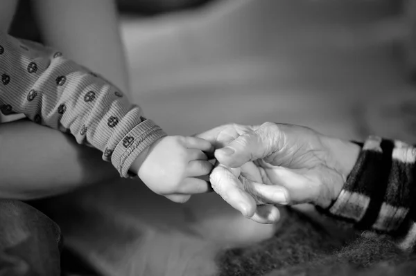 Great-grandmother and baby hands close up — Stock Photo, Image