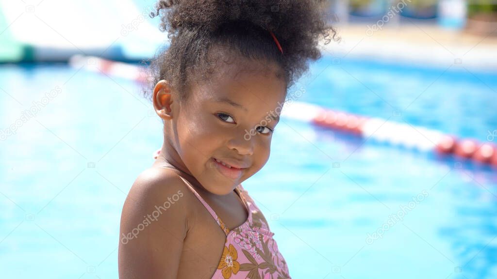 Portrait of African kid having fun on vacation at a water park