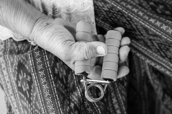 Senior asian woman exercise sport hand grip equipment — Stock Photo, Image