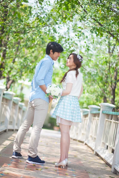 Loving asian couple under tree in the park — Stock Photo, Image