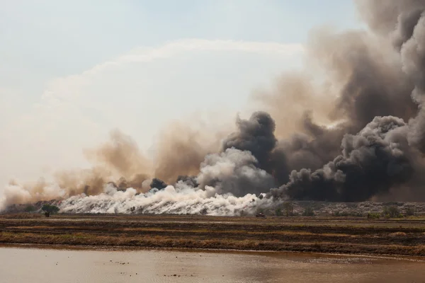 Brandende hoop vuilnis van rook — Stockfoto