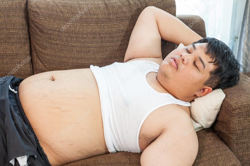 Fat asian man sleeping on the couch