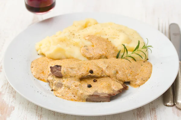 Fried pork with sauce and mashed potato on white plate — Stock Photo, Image