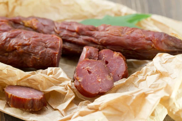 Smoked sausages on white plate — Stock Photo, Image