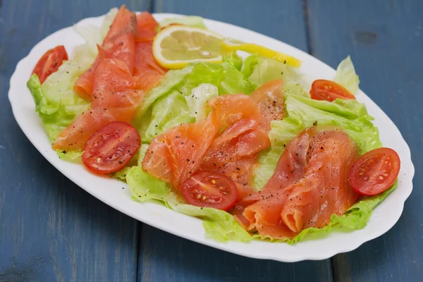 Salad with smoked salmon on white dish — Stock Photo, Image