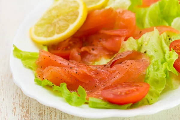 Salad with smoked salmon on white dish — Stock Photo, Image