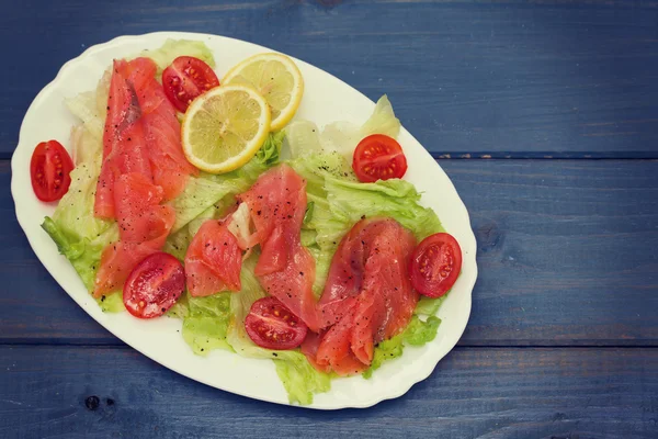 Salad with smoked salmon on white dish — Stock Photo, Image