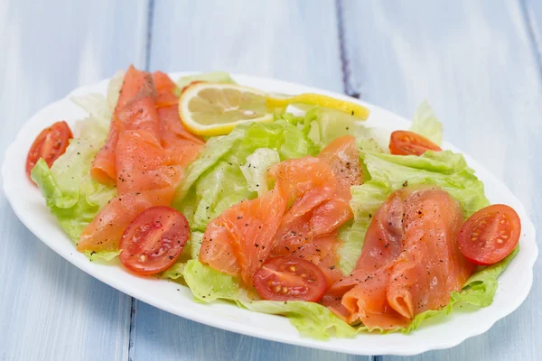 Salad with smoked salmon on white dish — Stock Photo, Image