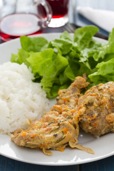 Rabbit with boiled rice and salad on white plate — Stock Photo, Image