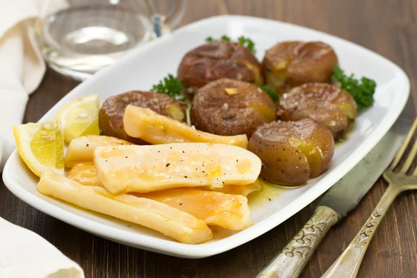 Octopus with potato on white dish — Stock Photo, Image