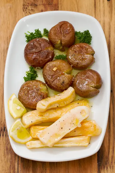 Octopus with potato on white dish — Stock Photo, Image