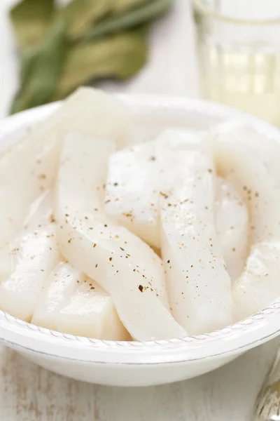 Strips of octopus on white dish on white background — Stock Photo, Image