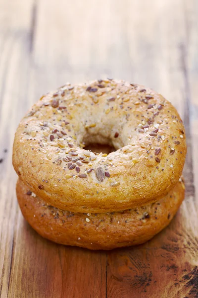 Fresh bagels on brown background — Stock Photo, Image