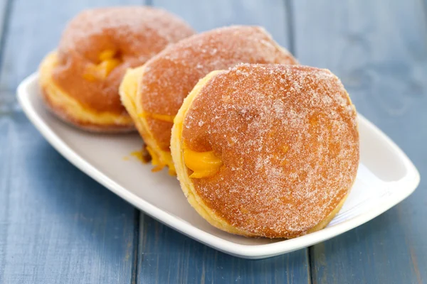 Donuts with cream on white dish — Stock Photo, Image