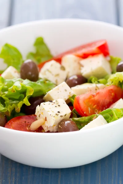 Insalata di formaggio con verdure in ciotola bianca su sfondo blu — Foto Stock