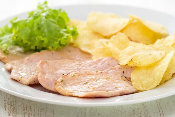 Carne frita com batatas fritas e salada fresca em prato branco — Fotografia de Stock