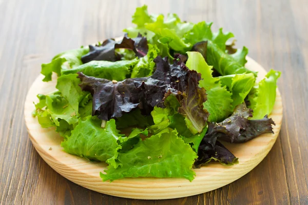 Salad on wooden dish — Stock Photo, Image