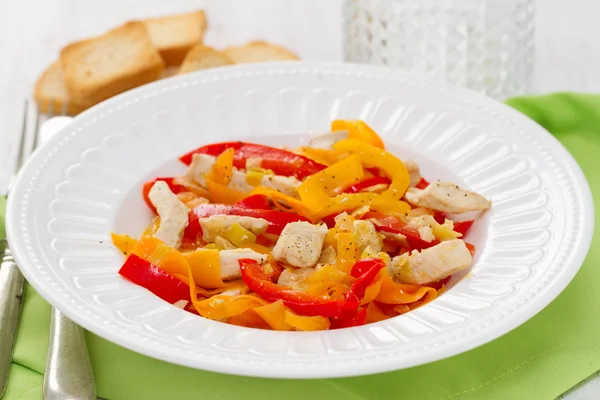 Chicken with pepper and carrot on white plate — Stock Photo, Image