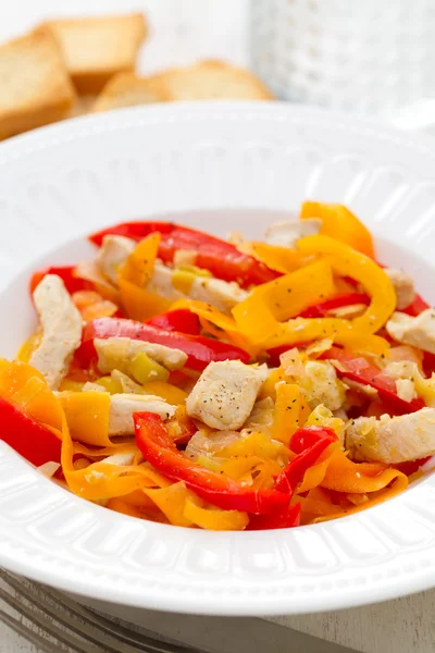 Chicken with pepper and carrot on white plate — Stock Photo, Image
