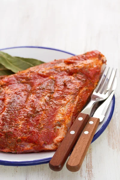 Marinated meat with fork and knife — Stock Photo, Image