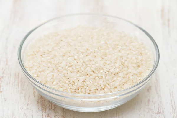 Raw rice in bowl — Stock Photo, Image