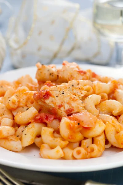 Pasta with fish and tomato sauce on white plate — Stock Photo, Image