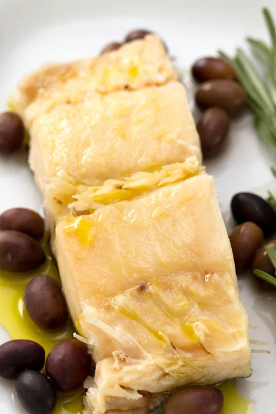 Boiled cod fish with olives — Stock Photo, Image