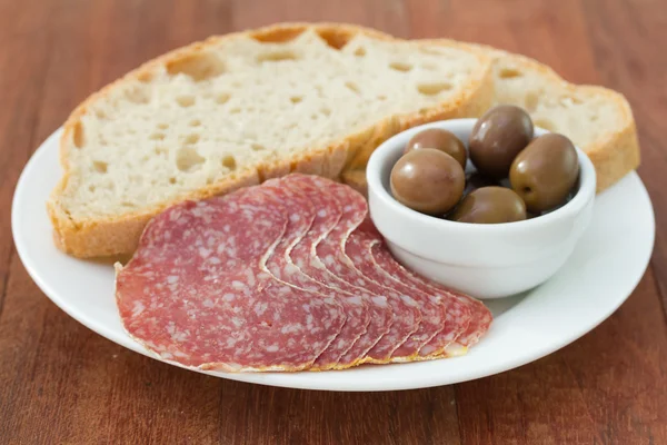 Salami with olive and bread — Stock Photo, Image