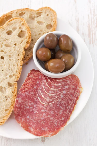 Salami with olive and bread — Stock Photo, Image