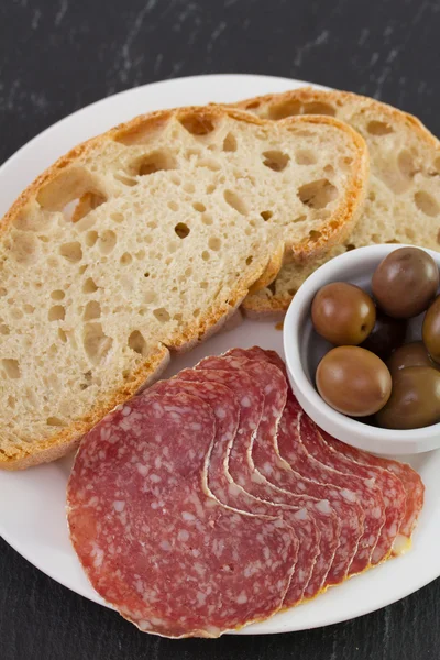 Salami with olives and bread — Stock Photo, Image
