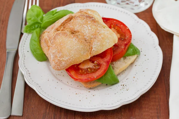 Sandwich with tomato and basil on plate — Stock Photo, Image