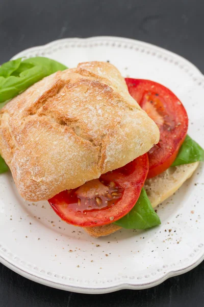 Sandwich with tomato and basil on plate — Stock Photo, Image