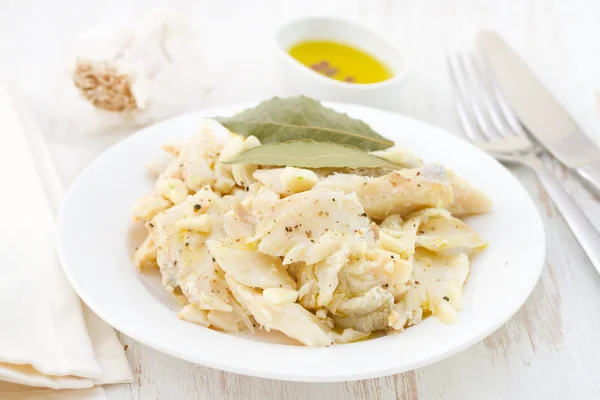 Codfish on white plate — Stock Photo, Image