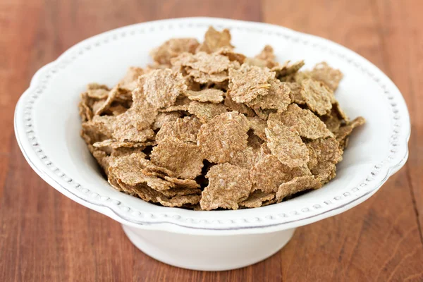 Flakes in white dish — Stock Photo, Image