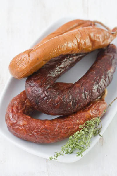 Smoked sausages on plate — Stock Photo, Image