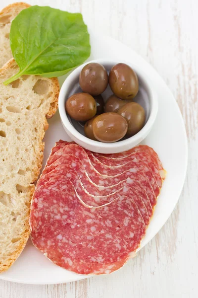 Sausages with bread, olives — Stock Photo, Image