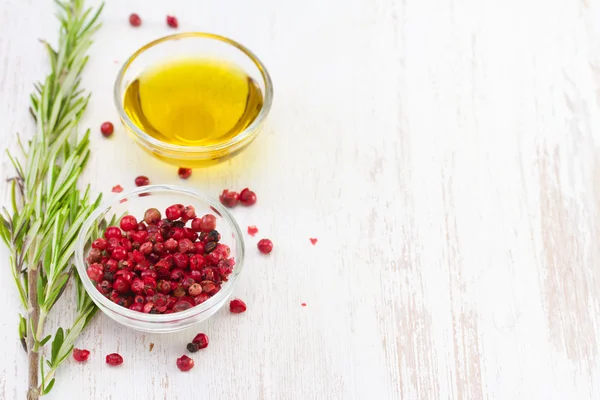 Pink pepper with olive oil — Stock Photo, Image