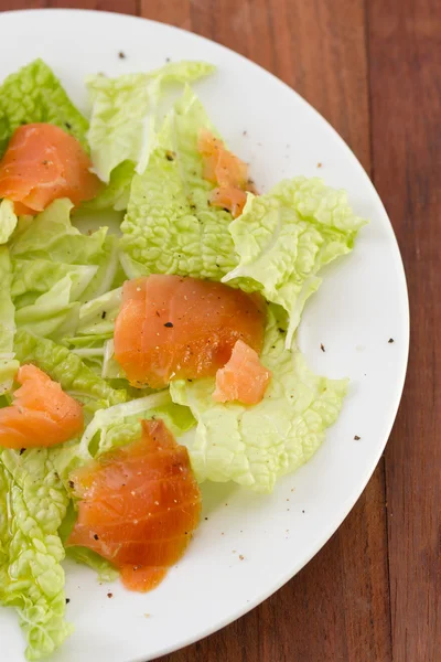 Salad with smoked salmon on white plate — Stock Photo, Image