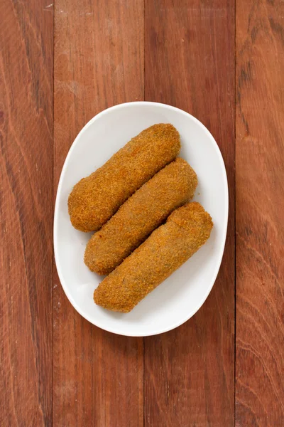 Meat croquete on white dish — Stock Photo, Image