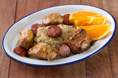 Pork with bread, smoked sausages and orange clipart