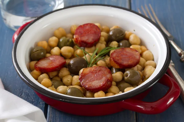 Chick pea with smoked sausages on dish — Stock Photo, Image