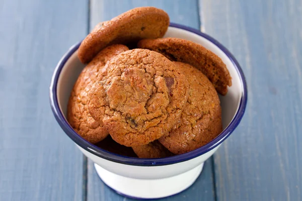 Cookies in bowl on brown wooden background