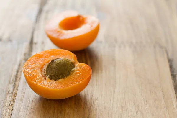 Apricot on brown wooden background — Stock Photo, Image