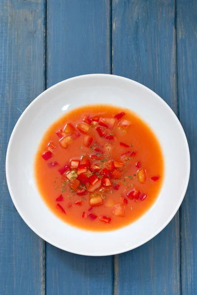 Gaspacho auf Platte auf blauem Holzhintergrund — Stockfoto