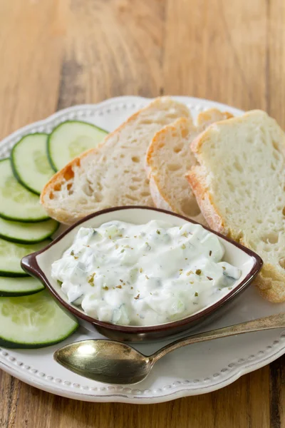 Cucumber dip with bread on white plate — Stock Photo, Image
