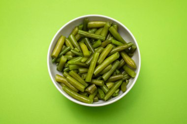 Chopped green beans boiled in white bowl