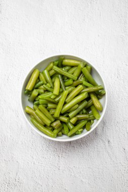 Chopped green beans boiled in white bowl