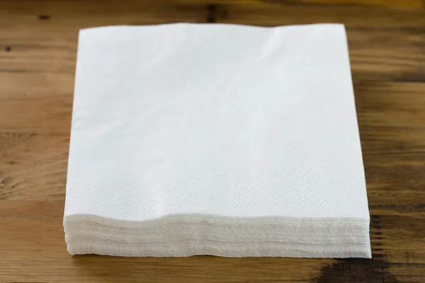 paper napkin on brown wooden background