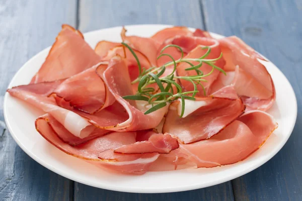 prosciutto on white plate