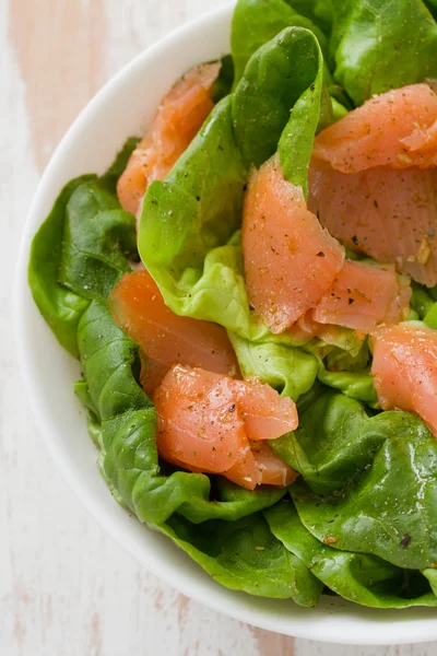 Salad with smoked fish on white bowl — Stock Photo, Image